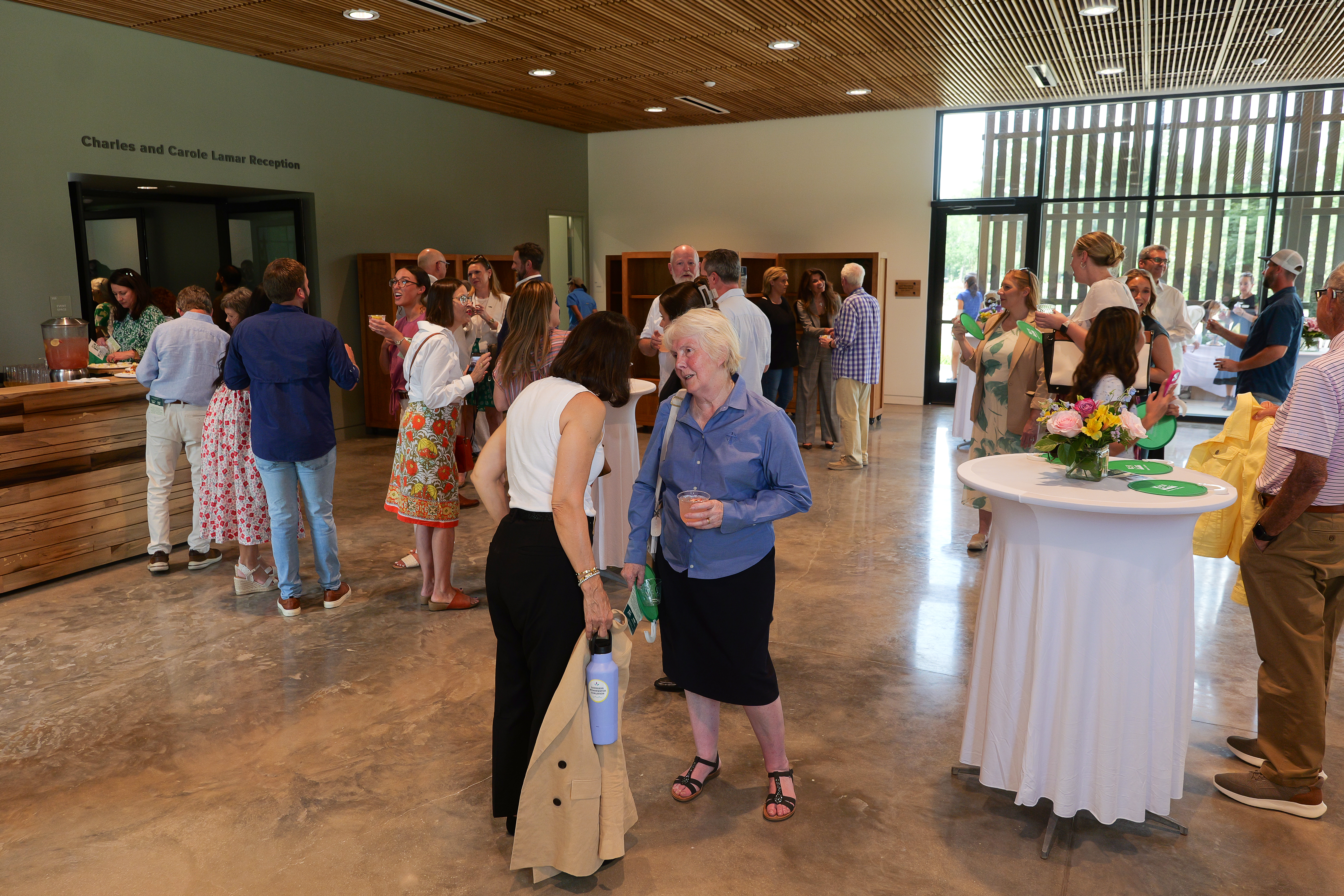 People talking with one another in a reception area.