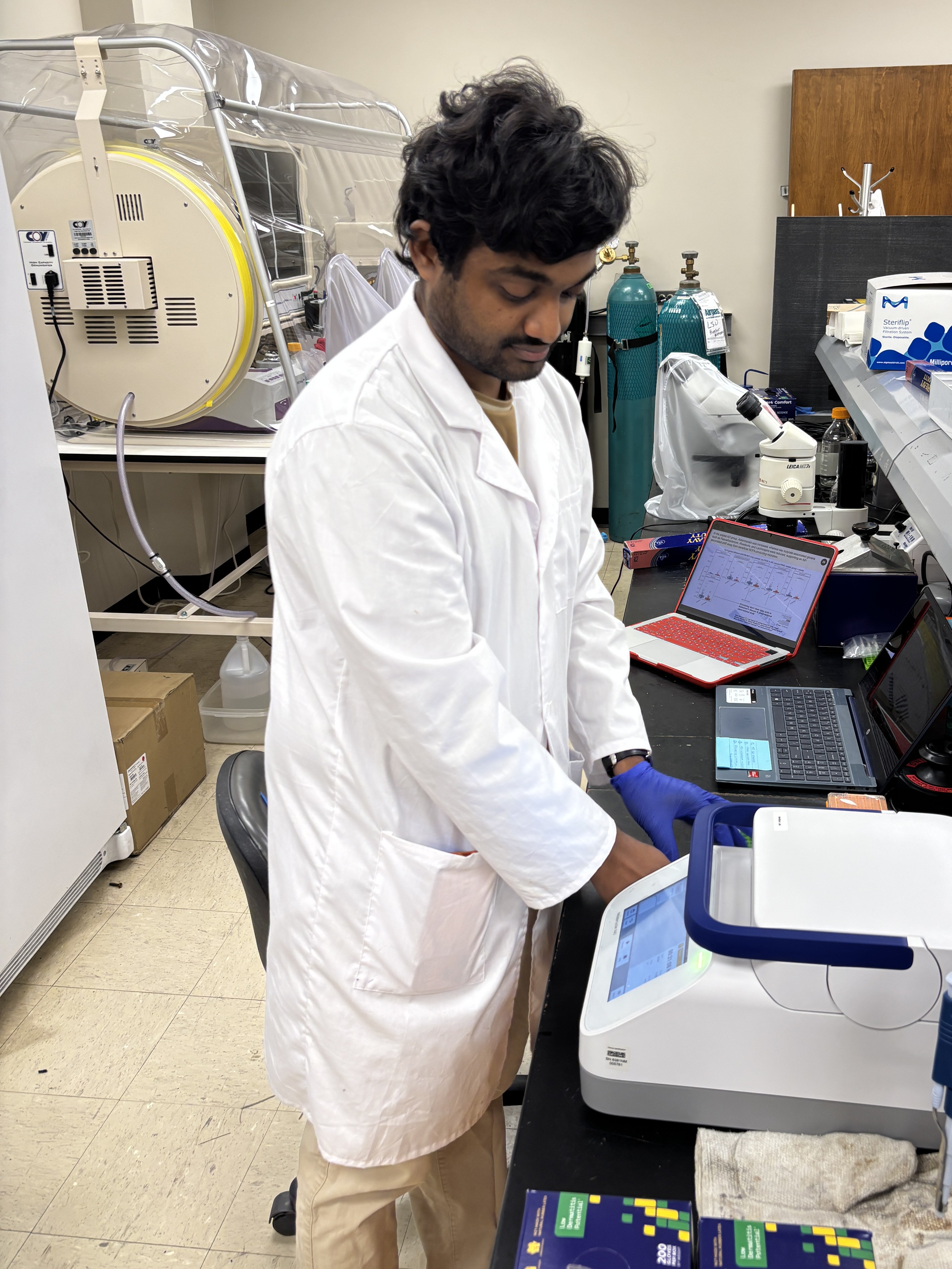 a man in a lab coat working in a lab