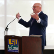 Matt Lee behind a podium.png thumbnail
